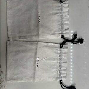 Mejuri Cream Pouches with Black Drawstrings